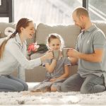 A joyful family enjoying quality time and coffee in a bright living room, symbolizing love and togetherness.